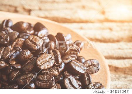 Close up of coffee beans on wooden spoon. Close up of coffee beans on wooden spoon. 34812347