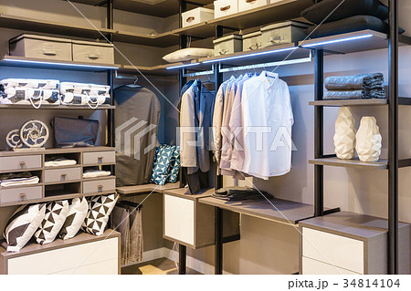 modern wooden wardrobe with cloth hanging on rail modern wooden wardrobe with cloth hanging on rail 34814104
