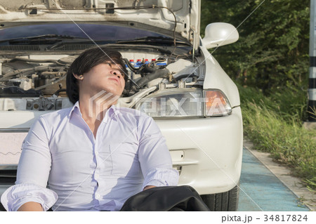 Stress man sitting on a broken car Stress man sitting on a broken car 34817824