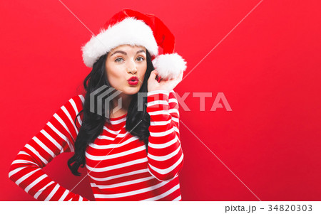 Happy young woman with Santa hat Happy young woman with Santa hat 34820303