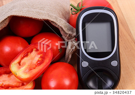 Tomatoes in jute bag and glucose meter 34820437