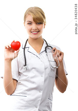 Woman doctor with stethoscope holding red heart Woman doctor with stethoscope holding red heart 34820438