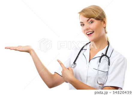 Woman doctor with stethoscope showing empty hand 34820439