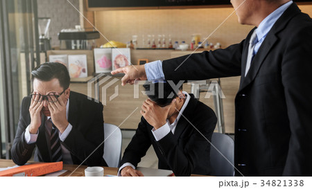 young businessman blamed and stressed by boss 34821338