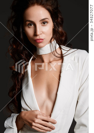 Attractive woman in white suit at studio Attractive woman in white suit at studio 34827077