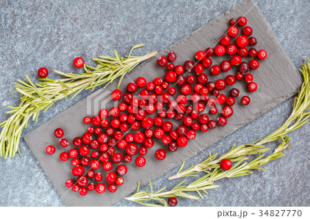Fresh red cranberries and rosemary on slate 34827770