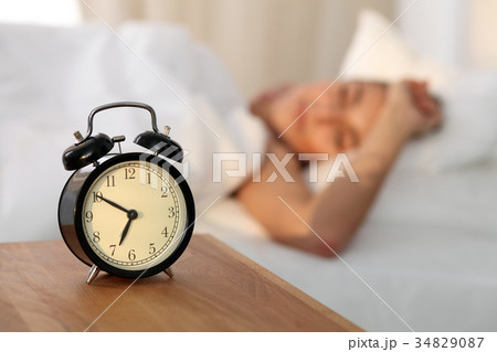 Beautiful young woman sleeping and smiling while 34829087