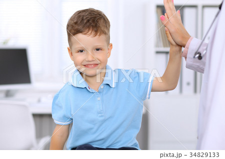 Happy little boy giving high five after health Happy little boy giving high five after health 34829133