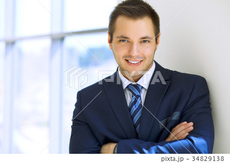 Smiling businessman in office Smiling businessman in office 34829138