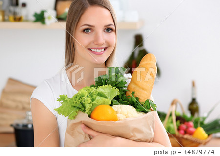 Young cheerful smiling woman is ready for cooking Young cheerful smiling woman is ready for cooking 34829774