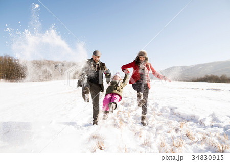 Father and mother with their daughter, playing in Father and mother with their daughter, playing in 34830915