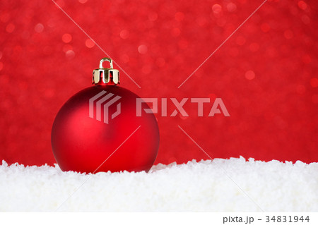 christmas red bauble in snow on red background christmas red bauble in snow on red background 34831944