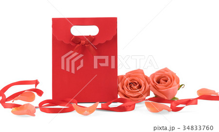 Red gift bag decorated with orange roses 34833760