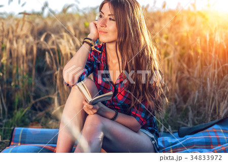 Girl sitting in a field shirt, wheat relaxing in 34833972