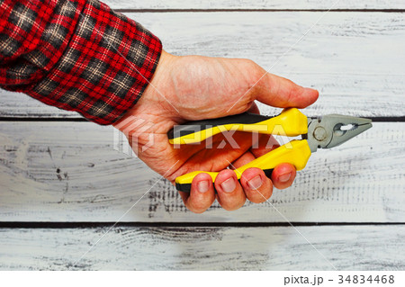 Male person holding pliers tool in hand 34834468
