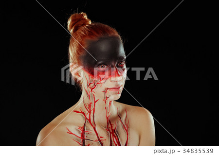 Mystic bloody girl with blood on her face 34835539
