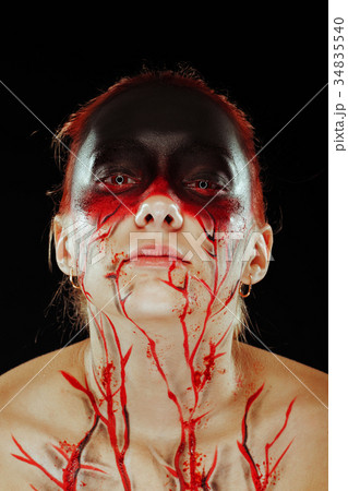 Mystic bloody girl with blood on her face 34835540