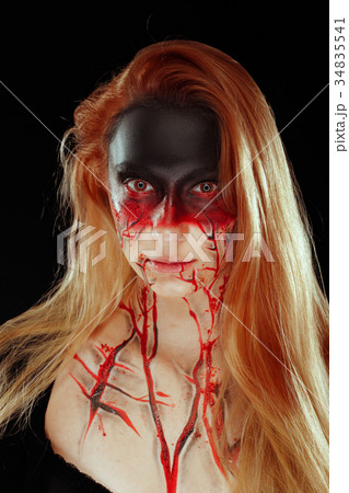 Mystic bloody girl with blood on her face 34835541