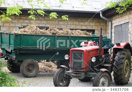 CLose up on tractor with the barn CLose up on tractor with the barn 34835706