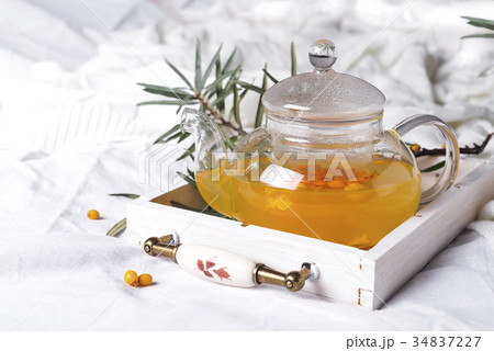 A glass teapot with sea buckthorn A glass teapot with sea buckthorn 34837227