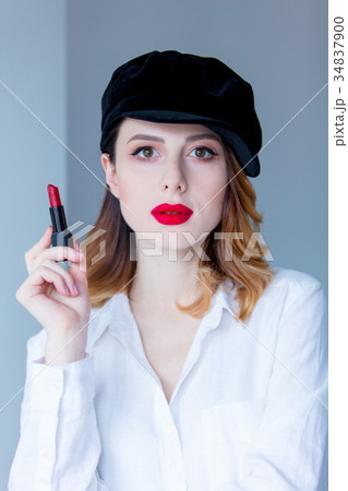 redhead woman in hat with lipstick for makeup 34837900