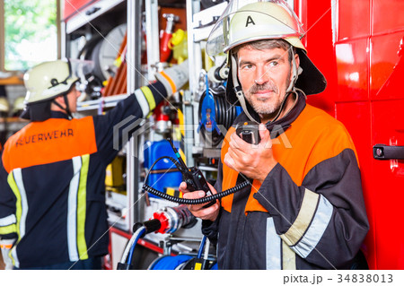 Chief fire fighter  checking radio set 34838013