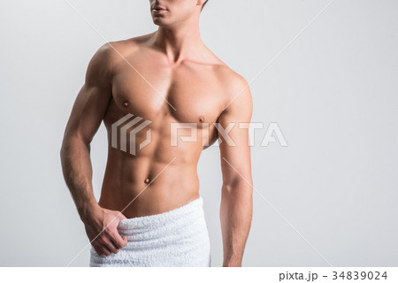 Attractive guy is posing against white wall Attractive guy is posing against white wall 34839024