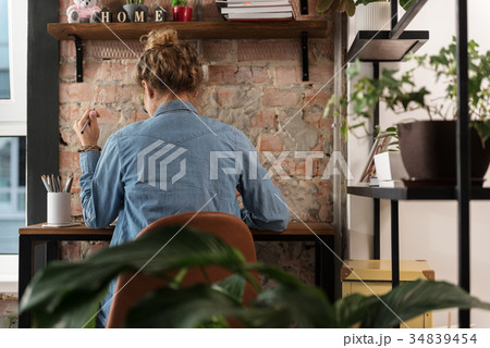 Young woman deep in work 34839454