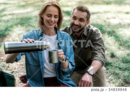 Joyful loving couple is ready to drink hot Joyful loving couple is ready to drink hot 34839948