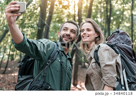 Happy man and woman photographing themselves on Happy man and woman photographing themselves on 34840118