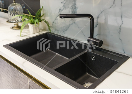 Black kitchen sink and Tap water in the kitchen. Black kitchen sink and Tap water in the kitchen. 34841265