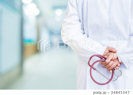 Doctor with stethoscope in his hand at hospital 34845347