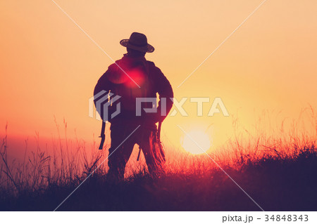 Silhouette Of  backpacker having fun at sunset  34848343