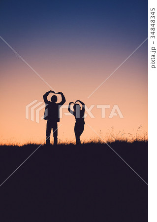 Silhouette Of People having fun at sunset time 34848345