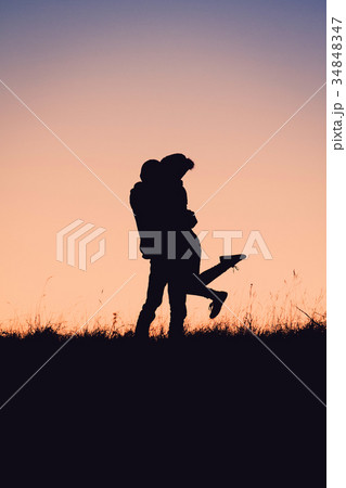 Silhouette Of People having fun at sunset time 34848347