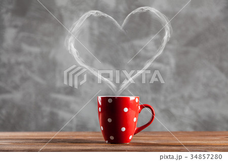 Cup of coffee with a heart shaped steam Cup of coffee with a heart shaped steam 34857280