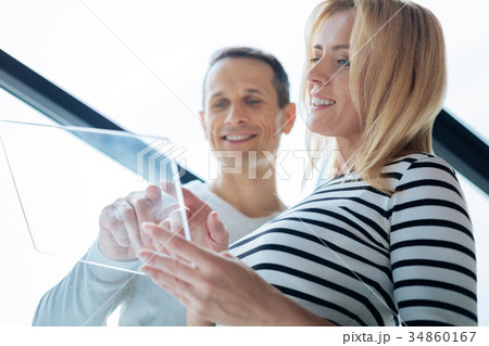 Attractive delighted woman holding a tablet 34860167