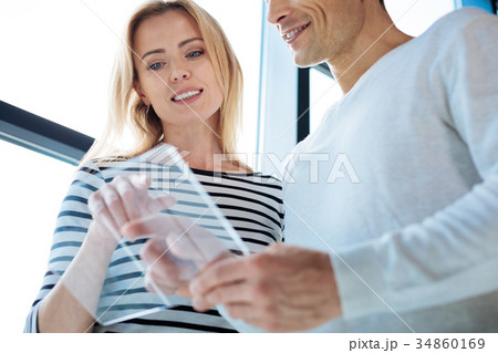 Attractive blonde woman pointing at the tablet Attractive blonde woman pointing at the tablet 34860169