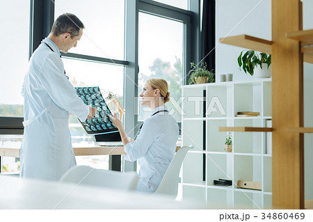 Positive smart doctors discussing an X ray scan 34860469