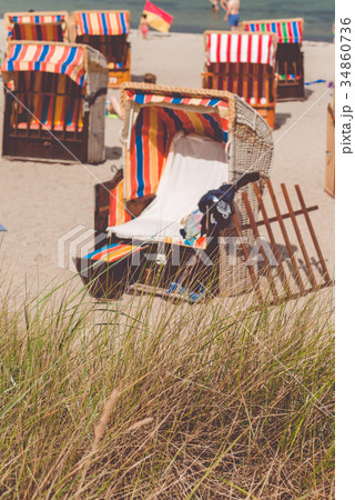 Rent red roofed chair on sandy beach in Travemunde Rent red roofed chair on sandy beach in Travemunde 34860736