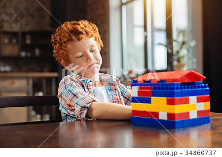 Thoughtful future architect examining his colorful Thoughtful future architect examining his colorful 34860737