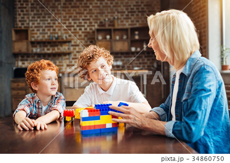 Curious boys listening to their granny Curious boys listening to their granny 34860750