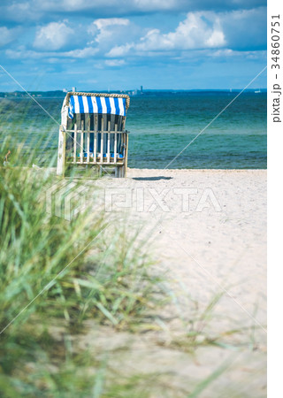 Blue colored roofed chairs on sandy beach in Blue colored roofed chairs on sandy beach in 34860751