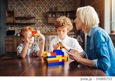 Redhead kid showing car toy to his grandma 34860752