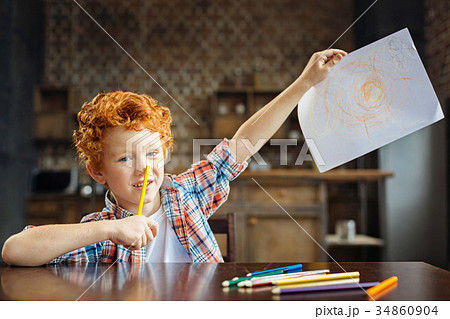 Smart little boy demonstrating his masterpiece 34860904