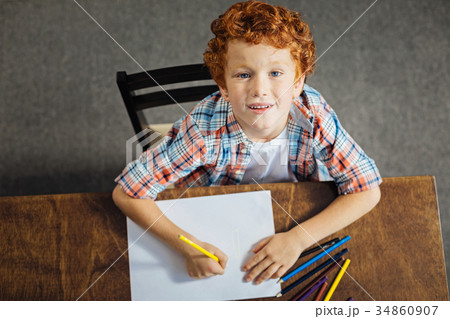 Beautiful redhead kid looking into camera while Beautiful redhead kid looking into camera while 34860907