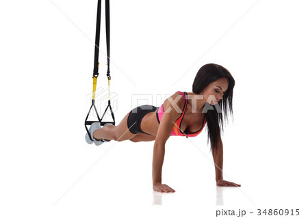 Woman exercising with suspension straps 34860915