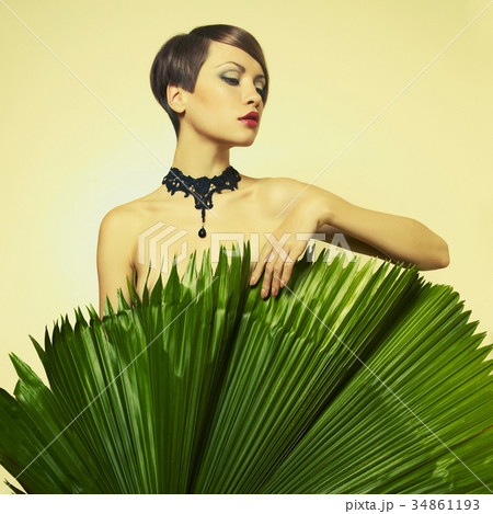 Beautiful lady with palm leaves 34861193