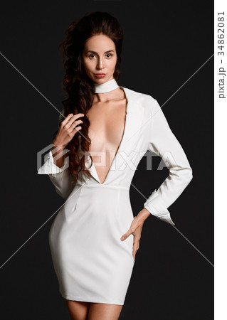Attractive woman in white suit at studio Attractive woman in white suit at studio 34862081