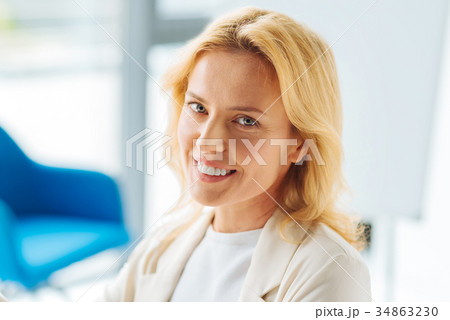 Portrait of smiling female that posing on camera Portrait of smiling female that posing on camera 34863230